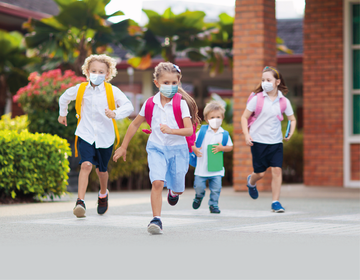 School child wearing face mask during corona virus and flu outbreak  Boy and girl going back to school after covid-19 quarantine and lockdown  Group of kids in masks for coronavirus prevention  