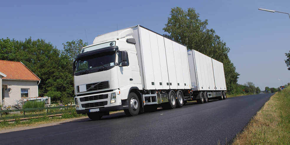 clean white lorry in the country on newly asphalted road