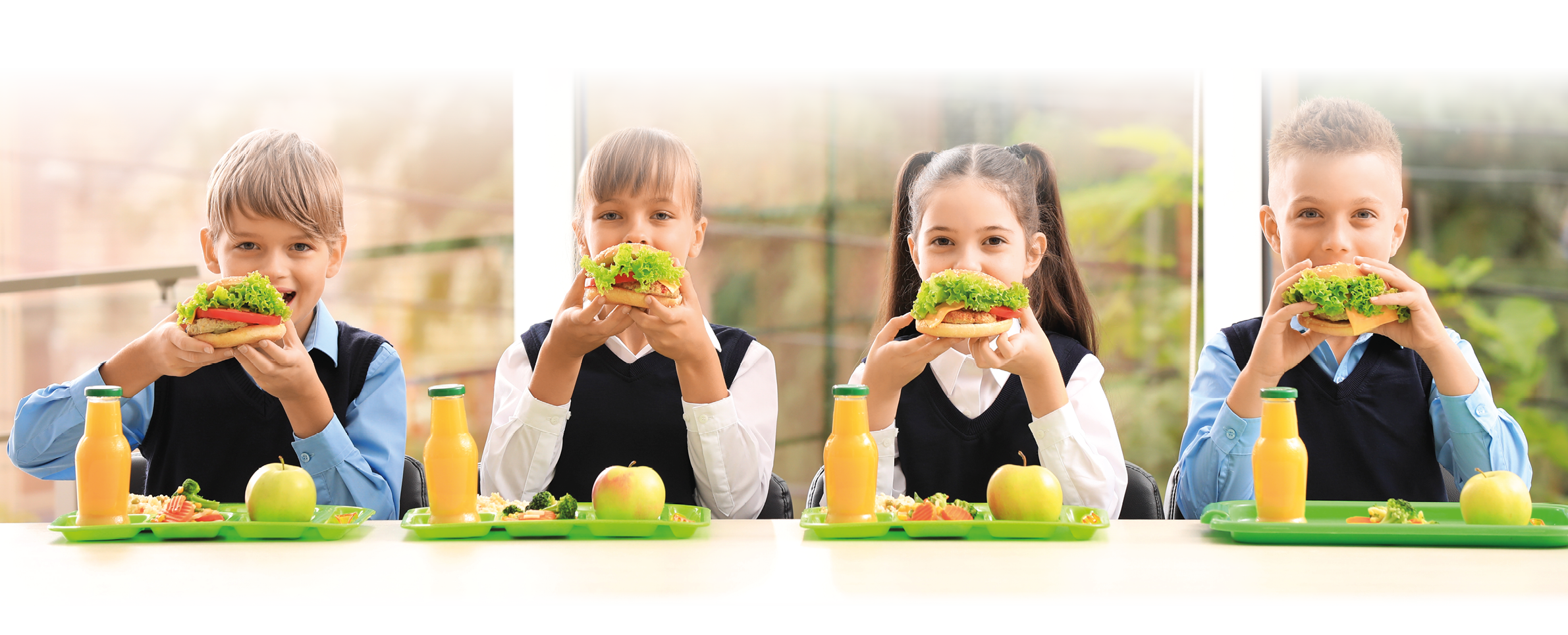 Happy children eating healthy food for lunch in school canteen