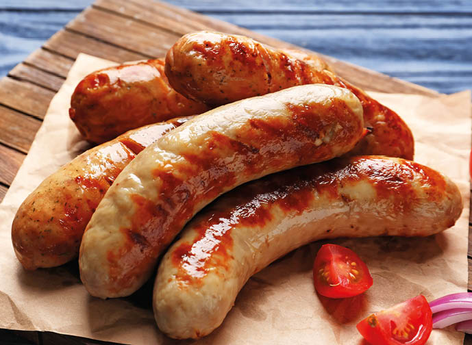 Grilled sausages on wooden board