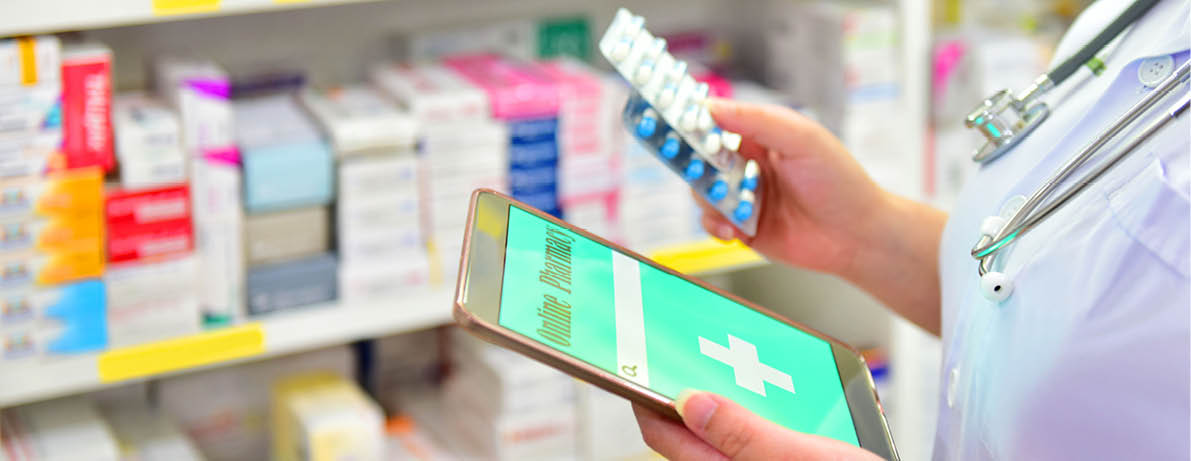 Pharmacist holding capsule pack and touch pad for search bar on display in pharmacy drugstore shelves background Online medical concept 