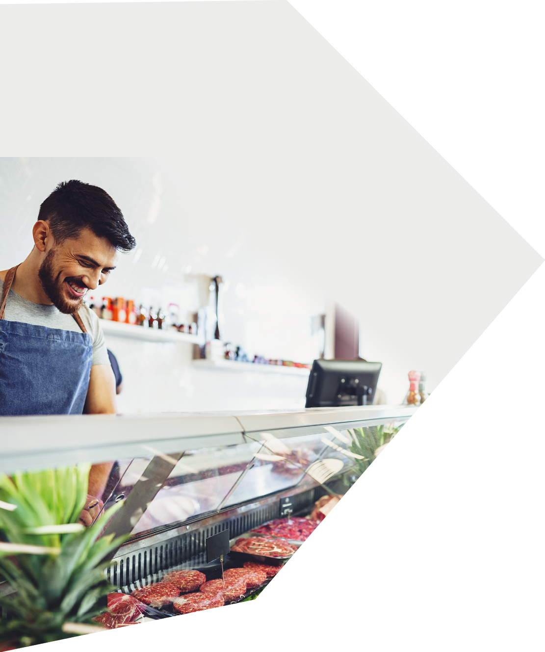 Butcher's shop seller helps to choose product to woman customer