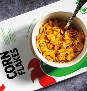 18 May 2021, Top view of a Kellogg's Corn Flakes package, with a bowl being prepared from above, Braga, Portugal 