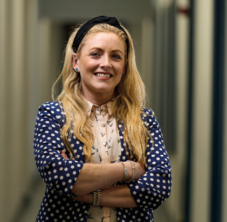 A person with her arms crossed  Description automatically generated with medium confidence