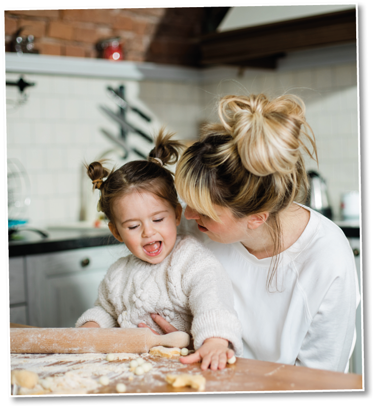 Mother and daughter baking cookies in their kitchen