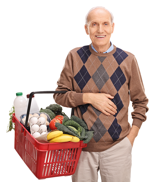 Cheerful senior gentleman holding a shopping basket full of groceries isolated on white background