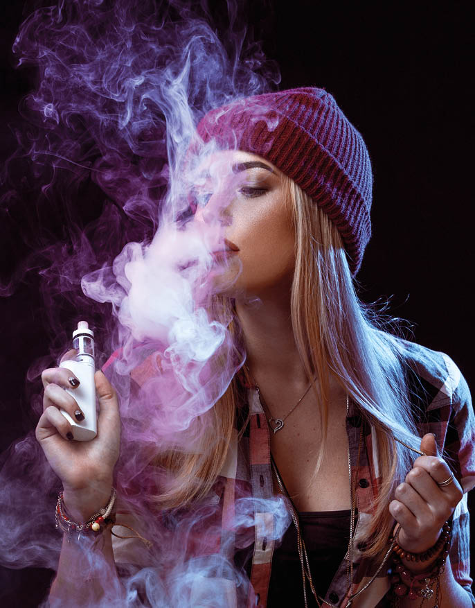 young woman smoking electronic cigarette