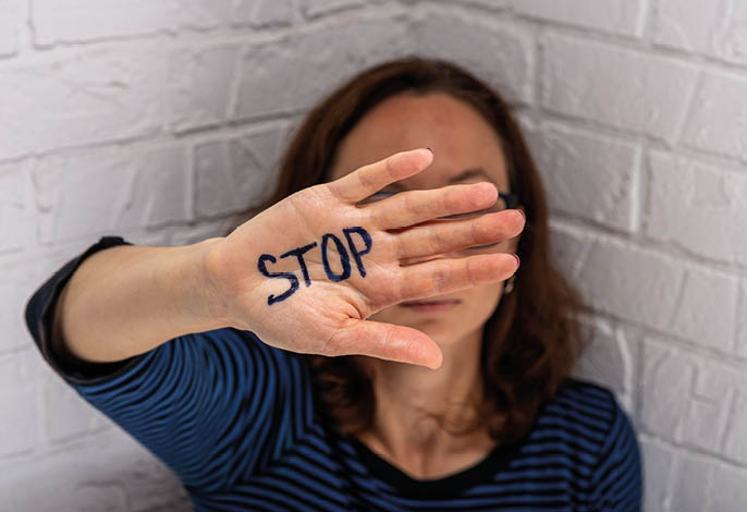 The woman shows the inscription STOP on her palm  Domestic Violence 