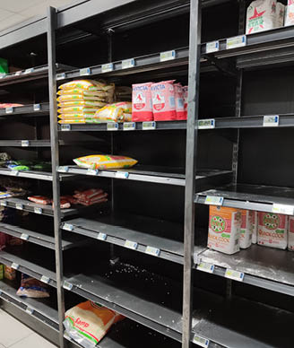 Cape Town, South Africa - March 24, 2020: Food shelves inside a grocery store with very little stock  Coronavirus (covid-19) panic buying concept image   
