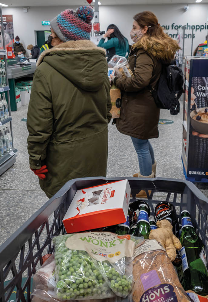London  UK- 01 26 2021: people shopping in a food supermarket where its compulsory to wear a face covering and practise social distancing 