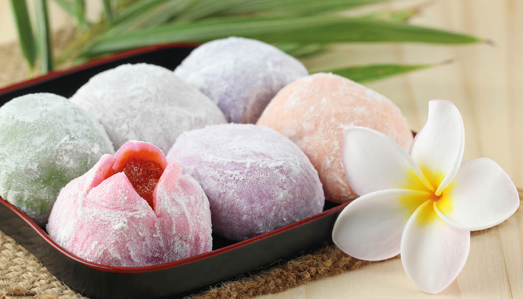 The colorful mochi Japanese dessert on wooden table, Close up photo with selective focus and toned image 