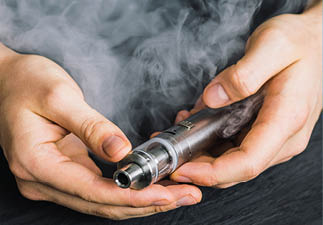 vape device at cloud of vapor background. Vape concept, toned Man hand shows vape device at cloud of vapor background. Vape co