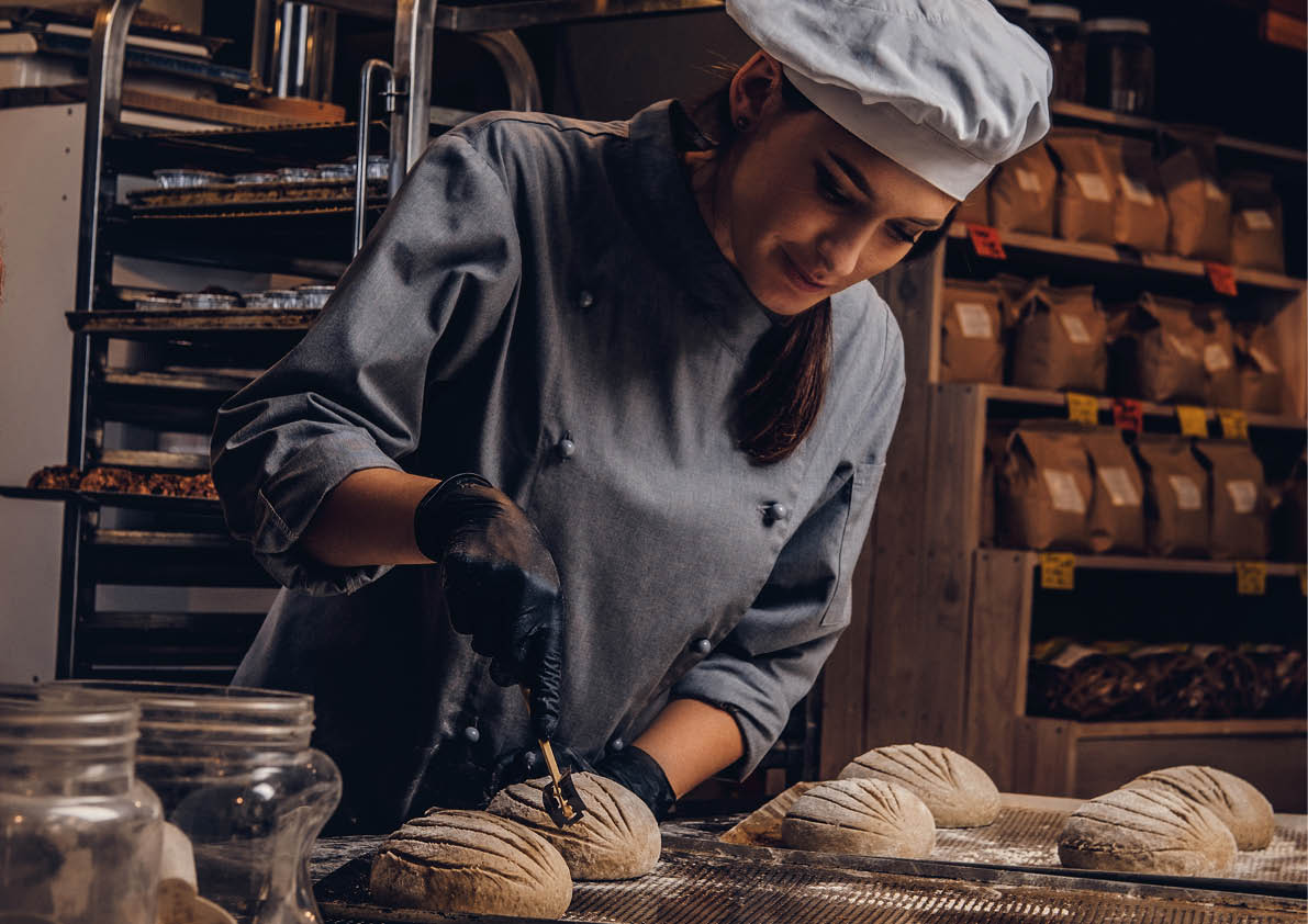 Cooking master class in bakery. Chef with his assistant showing ready samples of baking test in kitchen.