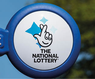 ARUNDEL, UK - May 5th 2018: Close-up of The National lottery Sign, on display outside a newsagents in the town of Arundel in West Sussex, on 5th May 2018.
