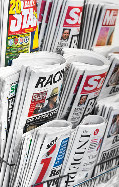 London, October 28, 2015: A newspaper rack found in central London, featuring several well known British tabloid newspapers, otherwise known as “the popular press".