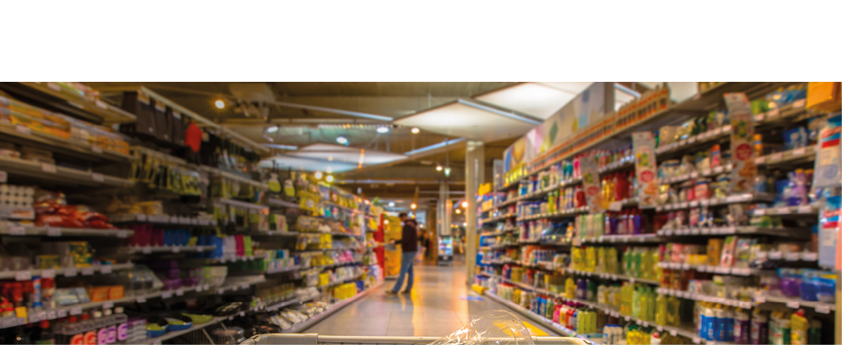 Supermarket trolley at an aisle filled up with healthy vegetables seen from the consumers point of view from above