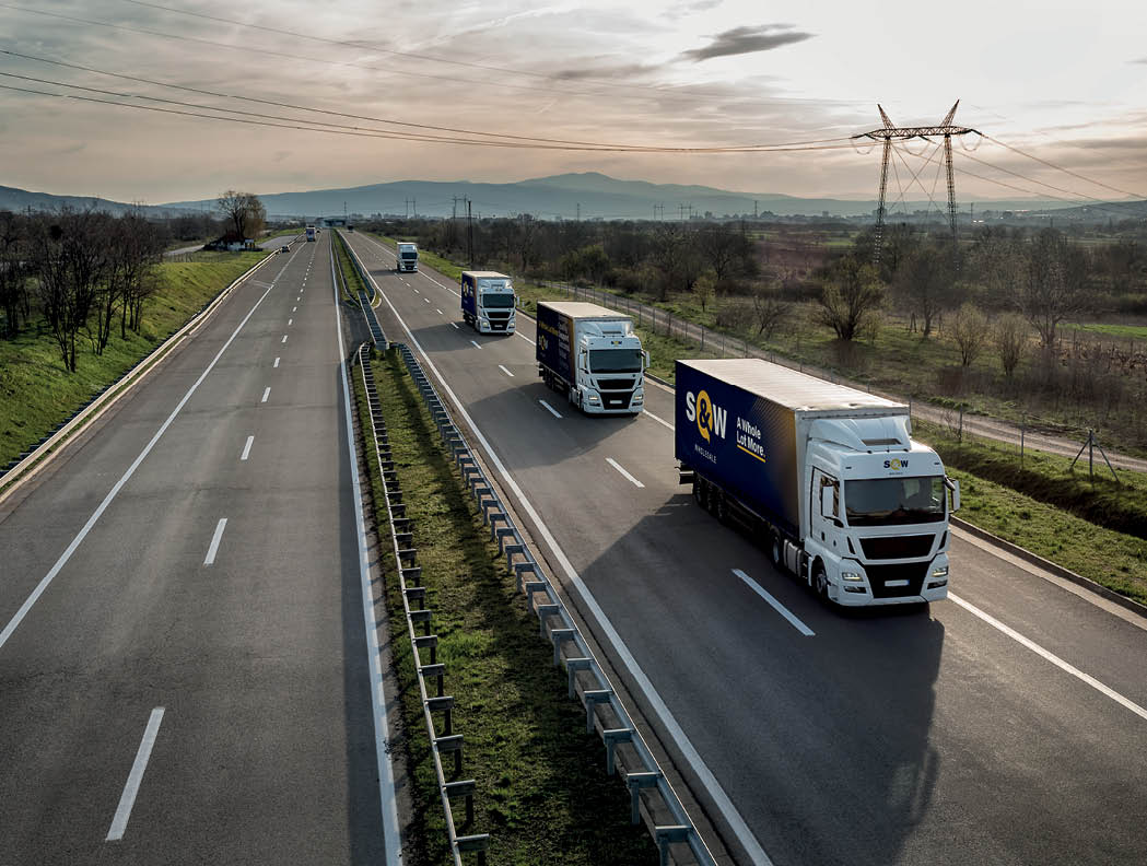 Caravan or convoy of trucks in line on a country highway
