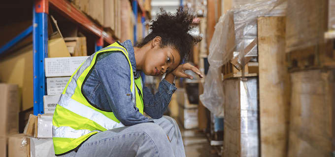 Tired stress woman worker labor working in warehouse cargo inventory industry.