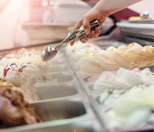 Woman serving ice cream in Confectionery shop