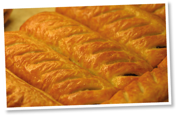 Freshly baked greggs sausage rolls in a shop window