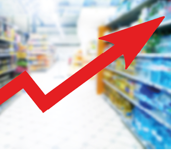 Red growing up large arrow on abstract blur image of supermarket background. Bar charts and graphs. Rising food prices. Inflation concept. Retail industry. Finance and Economy. Stock Market. Store.