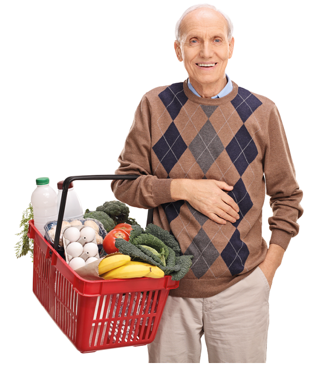 Cheerful senior gentleman holding a shopping basket full of groceries isolated on white background