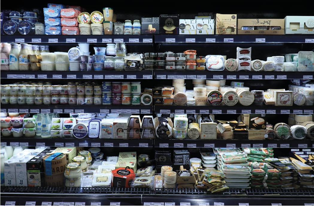 Barcelona, Spain - september 30th 2019: Cheese in a luxurious supermarket. Fridge filled with various sorts of prepacked cheese, food department El Corte Ingles