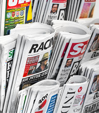 London, October 28, 2015: A newspaper rack found in central London, featuring several well known British tabloid newspapers, otherwise known as “the popular press".