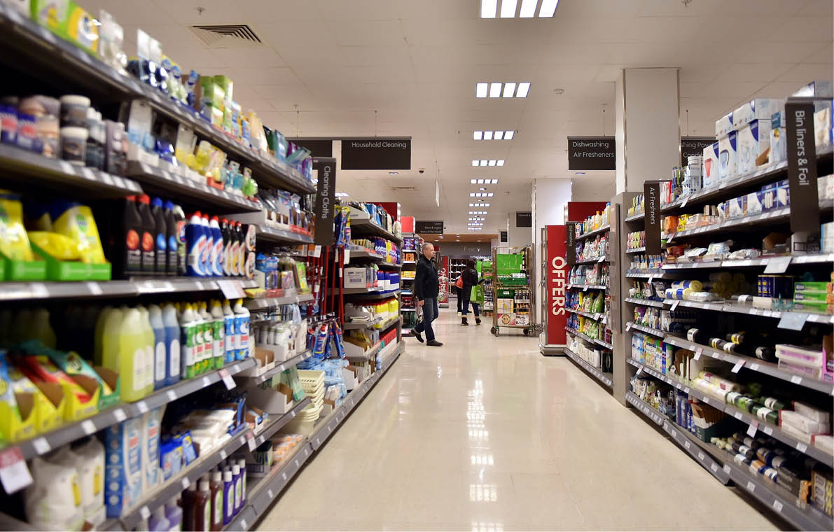 Bath, UK - February 10, 2016: People shop in an aisle in a Waitrose supermarket. Founded in 1904 Waitrose is the food retail division of the John Lewis, Britain's largest employee owned retailer.