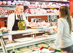 Shopkeeper serving a customer in a grocery store