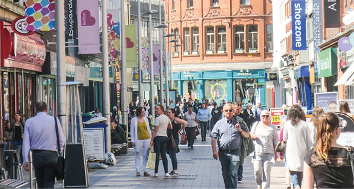BELFAST, NORTHERN IRELAND- MAY, 2018: Many people walking in Belfast city centre high street shopping area 