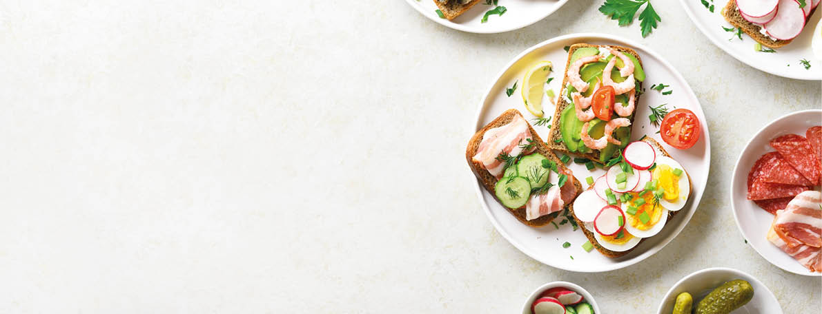 Sandwiches with meat, vegetables, seafood  Assortment open sandwiches on light stone background with free text space  Tasty healthy snack  Top view, flat lay 