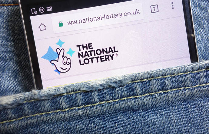KONSKIE, POLAND - MAY 18, 2018: The National Lottery website displayed on smartphone hidden in jeans pocket