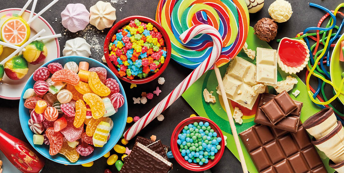 An assortment of colourful, festive sweets, ice-cream and candy in a panoramic orientation 