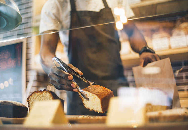 Black man works in pastry shop 