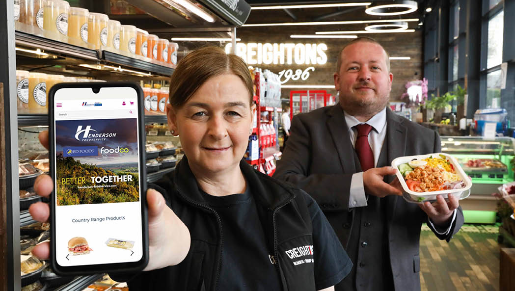 Elaine Williams, Development Manager with Creightons Group   a Henderson Foodservice customer, helps Chris Palmer, E-Commerce lead with Hendersons celebrate the company s Akeneo leadership award  