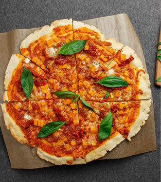 Gluten-free pizza with pumpkin and basil on a neutral gray tissue background  A slice of pizza  The Italian meal  Pizza without gluten 