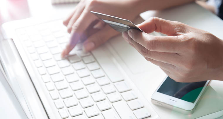 Hand holding credit card and using laptop  Online shopping