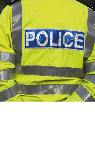 Shot of the back of a police officer's jacket with the word police written across the back