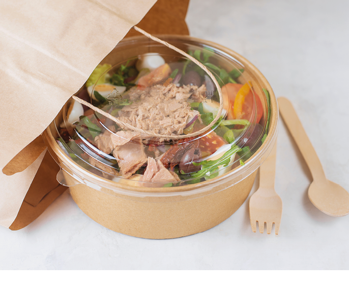 Fish diet salad with tuna, tomatoes, arugula on light background. Healthy vegetarian lunch. Concept eco restaurant delivery, environment protection. Take away food in brown paper craft plate. 