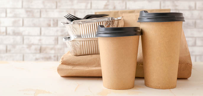 Assortment of food delivery containers on table