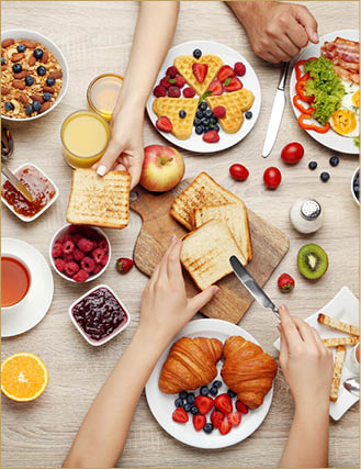 Happy family having tasty breakfast in the morning