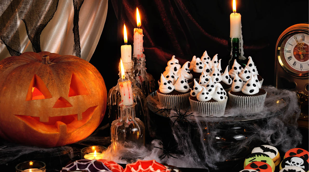 Chocolate muffin meringues with meringues on the table in honor of Halloween