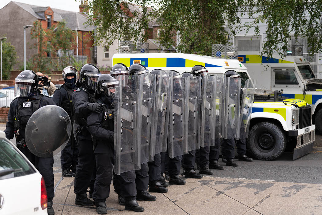 Belfast - Northern Ireland August 3 2024 PSNI wall pushing back protest near University Road during march 