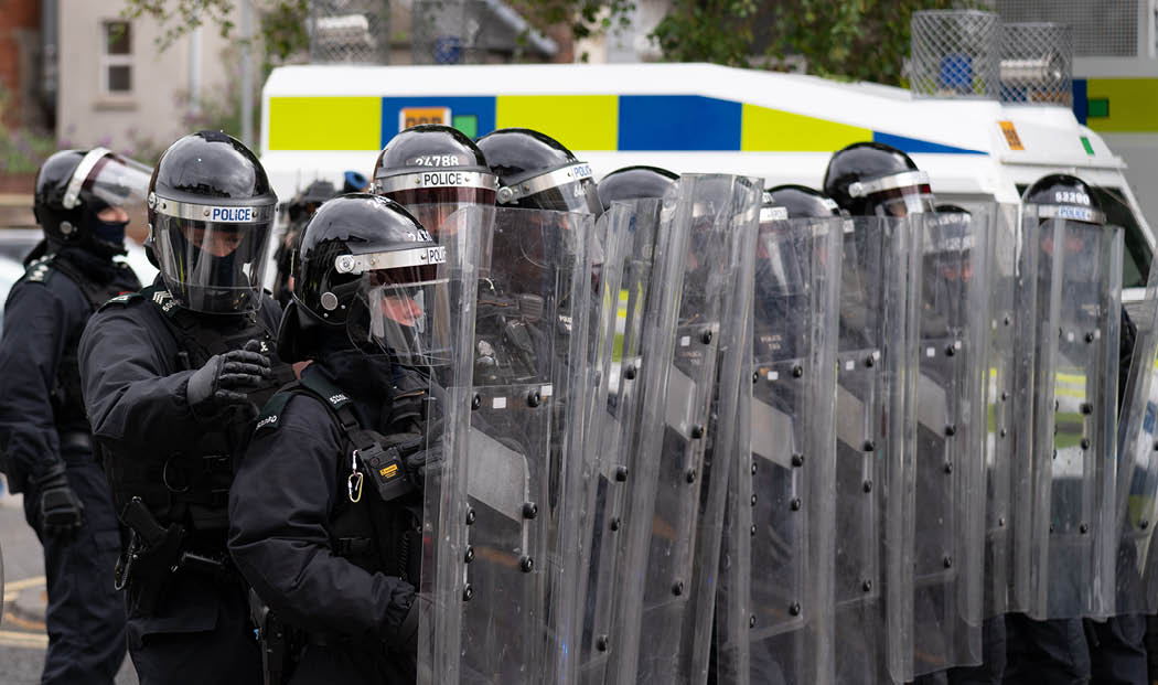 Belfast - Northern Ireland August 3 2024 PSNI wall pushing back protest near University Road during march 