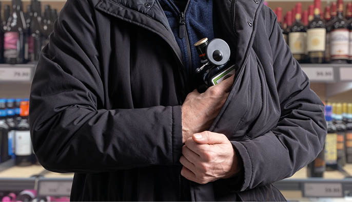 theft incident as a shoplifter attempts to steal a bottle of alcohol equipped with a Magnetic RF Bottle Tag security device, shoplifting anti-theft protection in-store operations.