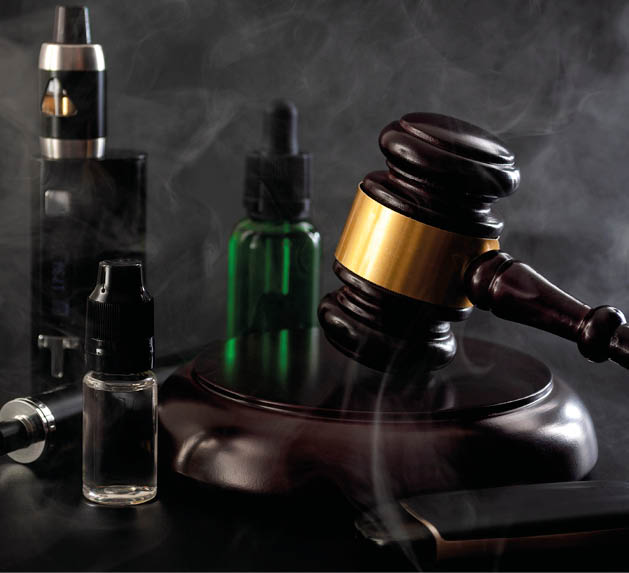 Legal act to restrict vaping, outlaw smoking electronic cigarettes and vape ban legislation conceptual idea with judge gavel, vape device, bottle of ejuice and some isolated on black background