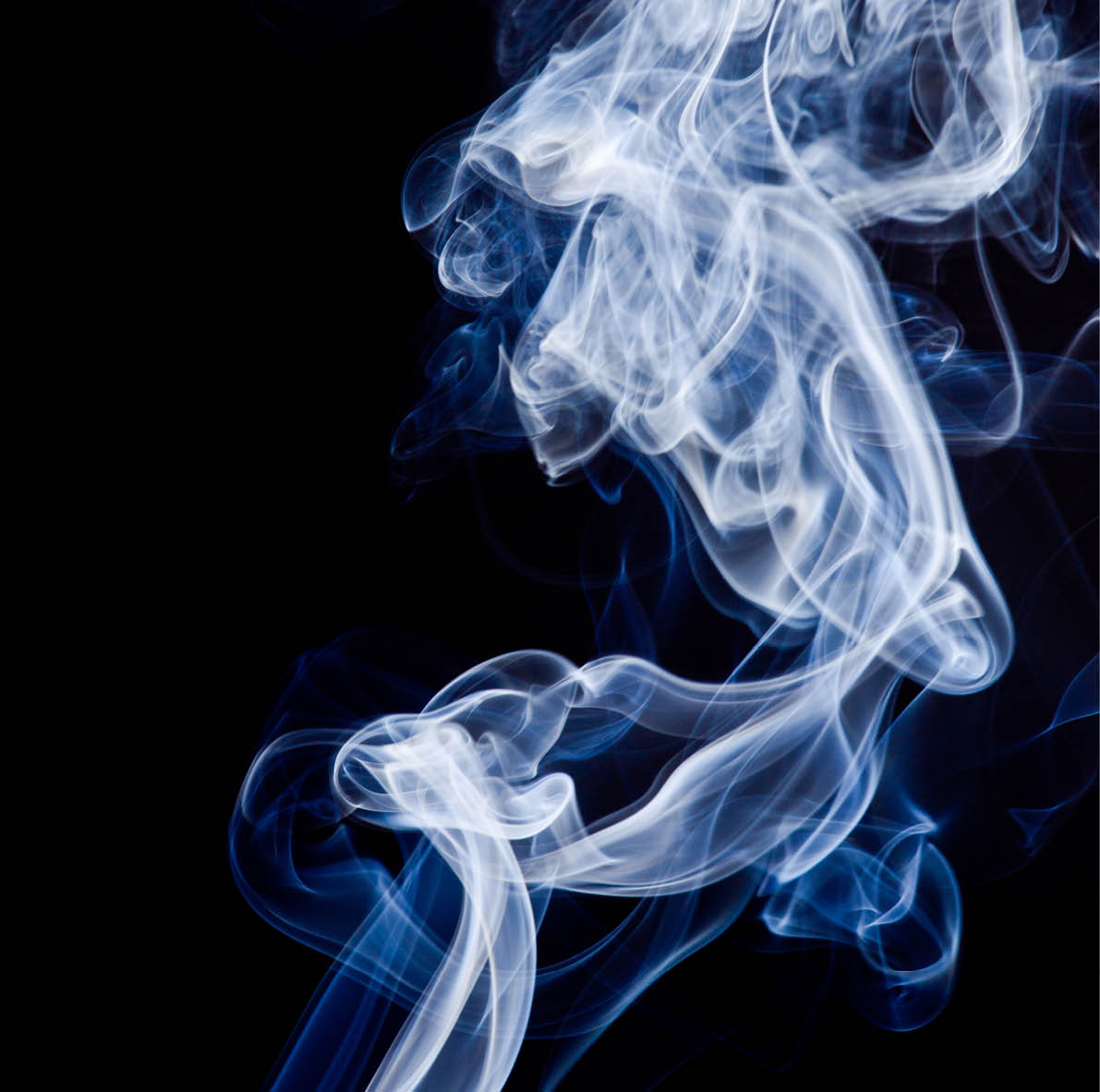 Tobacco smoke. On black background.
