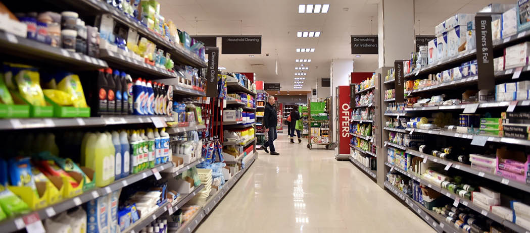 Bath, UK - February 10, 2016: People shop in an aisle in a Waitrose supermarket. Founded in 1904 Waitrose is the food retail division of the John Lewis, Britain's largest employee owned retailer.