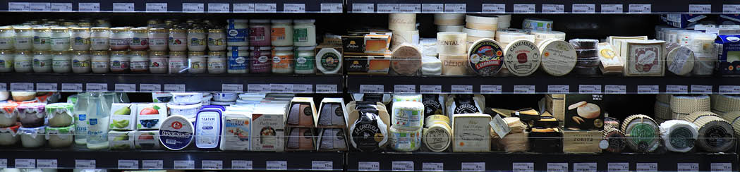 Barcelona, Spain - september 30th 2019: Cheese in a luxurious supermarket. Fridge filled with various sorts of prepacked cheese, food department El Corte Ingles